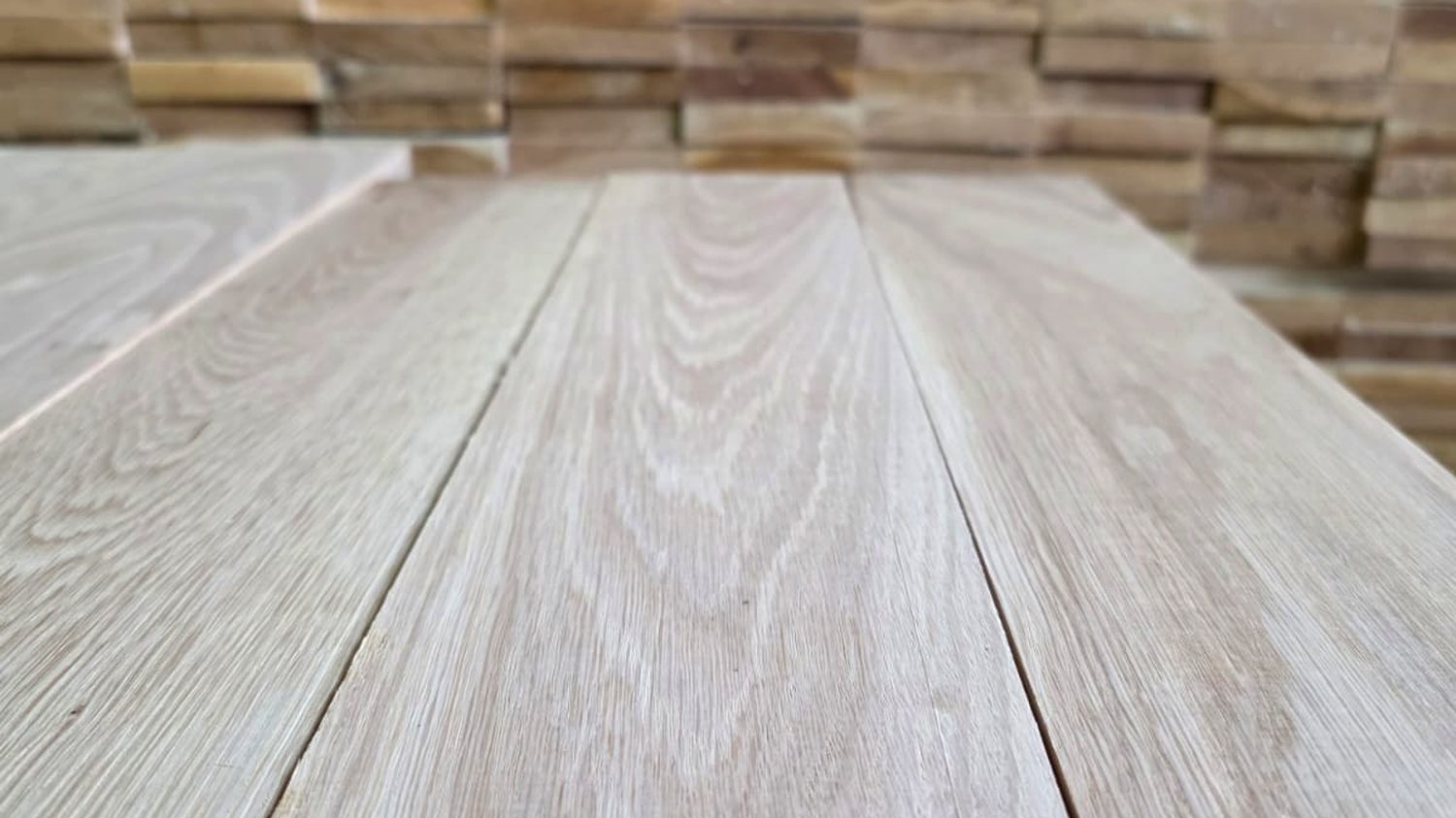 Planed Slavonian oak boards in front of stacked elements