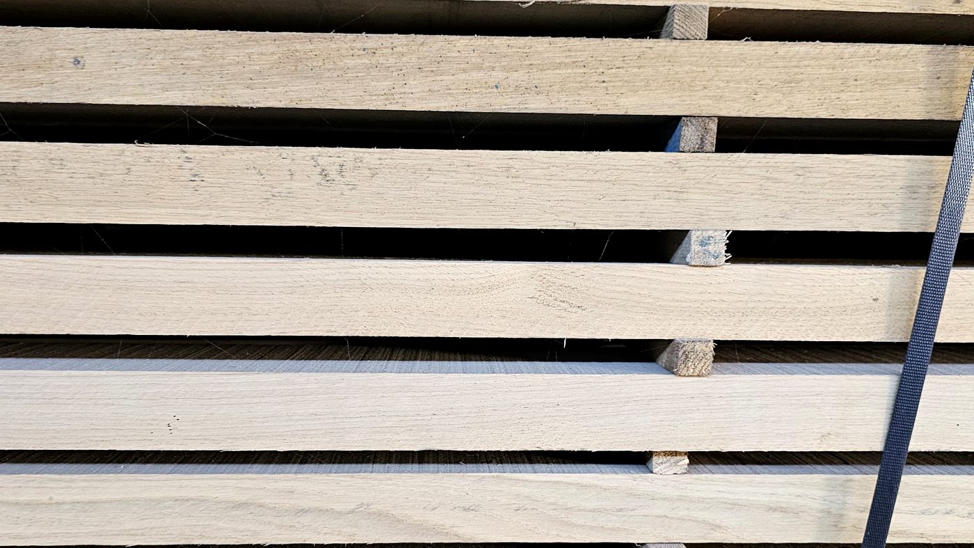 Oak boards stacked on stickers